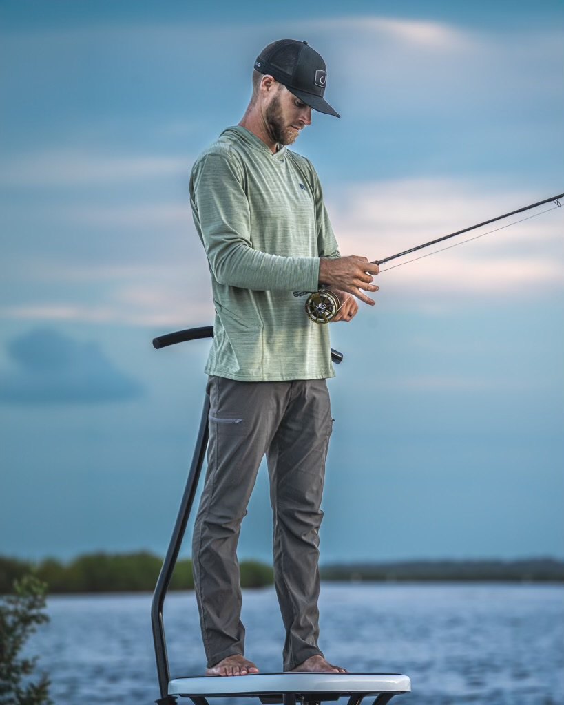Jesse Hardy preparing a fly rod on a skiff